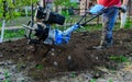 Farmer man works in the garden field with motor cultivator Royalty Free Stock Photo