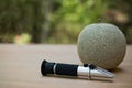 Measures the sugar content of organic melon with Brix refractometer Royalty Free Stock Photo