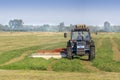 Farmer mowing the grass using a tractor with a mower