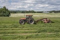 Farmer mowing hay mower in field.