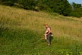 Farmer Mowing Meadow with Trimmer on Hot Summer Day - Rural Landscaping
