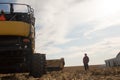 Farmer in his Recently Harvested Field with Combine Royalty Free Stock Photo