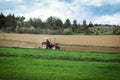 Farmer on a tractor plowing the field