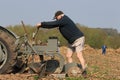 Farmer mending plough of old vintage tractors at ploughing match Royalty Free Stock Photo