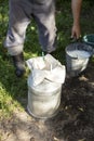 Farmer passes the milk through the strainer, the old way of cleaning milk from dirt