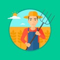Farmer with pitchfork in wheat field. Royalty Free Stock Photo