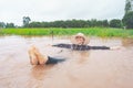 Farmer playing and joyful in heavy flood in rice field