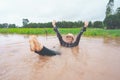 Farmer playing and joyful in heavy flood in rice field