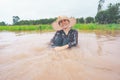 Farmer playing and joyful in heavy flood in rice field