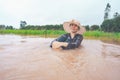 Farmer playing and joyful in heavy flood in rice field