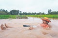 Farmer playing and joyful in heavy flood in rice field