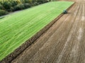 Farmer ploughing a field, aerial view