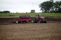 Farmer plowing the field Cultivating tractor in the field Red farm tractor with a plow in a farm field Tractor and Plow. Lithuania