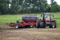 Farmer plowing the field Cultivating tractor in the field Red farm tractor with a plow in a farm field Tractor and Plow. Lithuania