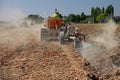 Farmer plowing the field with an old crawler tractor Royalty Free Stock Photo