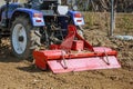 Farmer plows the field. Small tractor with a plow in the field. Cultivation Royalty Free Stock Photo