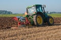 Farmer plowing the harvested cornfield