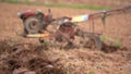 Farmer plowing rice field for planting in organic farm agriculuture in Thailand