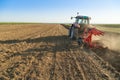 Farmer plowing stubble field with red tractor Royalty Free Stock Photo