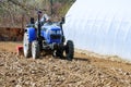 Farmer plows the field. Small tractor with a plow in the field. Cultivation Royalty Free Stock Photo