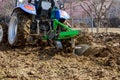 Farmer plows the field. Small tractor with a plow in the field. Cultivation Royalty Free Stock Photo