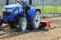 Farmer plows the field. Small tractor with a plow in the field. Cultivation Royalty Free Stock Photo