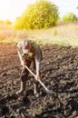 Farmer plows the land with a shovel