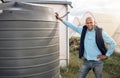 Farmer, portrait and water tank in farming liquid or soil hydration for vegetables, food or crops growth. Irrigation Royalty Free Stock Photo