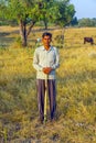 Farmer poses in front of his cows