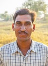 Farmer poses proud in his field