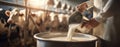 The farmer pouring fresh milk from a container at a dairy farm. AI generated image Royalty Free Stock Photo