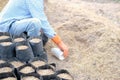 Farmer pouring substrate materials for growing plant. soil fertilizer in planting bag for transplanting seedling Royalty Free Stock Photo