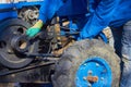farmer repairs the tractor,a man installs the engine belt of a two-wheeled tractor Royalty Free Stock Photo