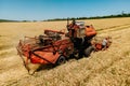 farmer rides an old combine to work. Combine harvester goes on way to harvest wheat. Royalty Free Stock Photo