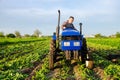 The farmer rides towards on farm field. Harvesting crops campaign, earthworks. Agro industry, agribusiness. Farming, agriculture.