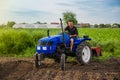 Farmer rides a tractor across the field. Milling soil. Work in the field and preparation of the land for planting of seedlings Royalty Free Stock Photo