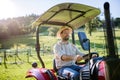 Farmer riding tractor on field. Harvesting crops, collecting vegetables on family farm. Concept of farming, agricultural Royalty Free Stock Photo