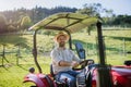 Farmer riding tractor on field. Harvesting crops, collecting vegetables on family farm. Concept of farming, agricultural Royalty Free Stock Photo