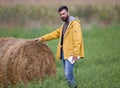 Farmer with rolled bale