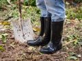 Farmer in rubber boots standing in the field. farm concept. Royalty Free Stock Photo