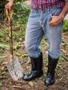 Farmer in rubber boots standing in the field. farm concept. Royalty Free Stock Photo