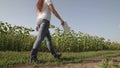 a farmer in rubber boots walks across the field with tablet in his hand, farming, an agronomist working on plantation of Royalty Free Stock Photo