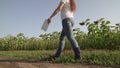 a farmer in rubber boots walks across the field with tablet in his hand, farming, an agronomist working on plantation of Royalty Free Stock Photo