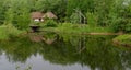 Farmer's house reflecting in a pond in open air museum, Kiev, Ukraine