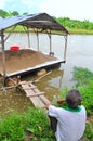 A farmer is sad looking at his pangsius catfish farm in the mekong delta of Vietnam. Pangasius is stuck in the US market because Royalty Free Stock Photo