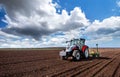 Farmer seeding, sowing crops at field. Royalty Free Stock Photo