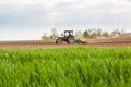 Farmer seeding, sowing crops at field.