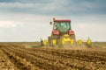 Farmer seeding, sowing crops at field.