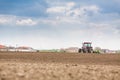 Farmer seeding, sowing crops at field. Sowing is the process of planting seeds in the ground as part of the early spring time agri Royalty Free Stock Photo