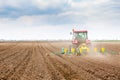 Farmer seeding, sowing crops at field. Sowing is the process of planting seeds in the ground as part of the early spring time agri